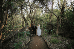 Bride & groom on forest path