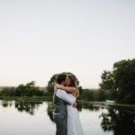 Bride and groom kiss at dam